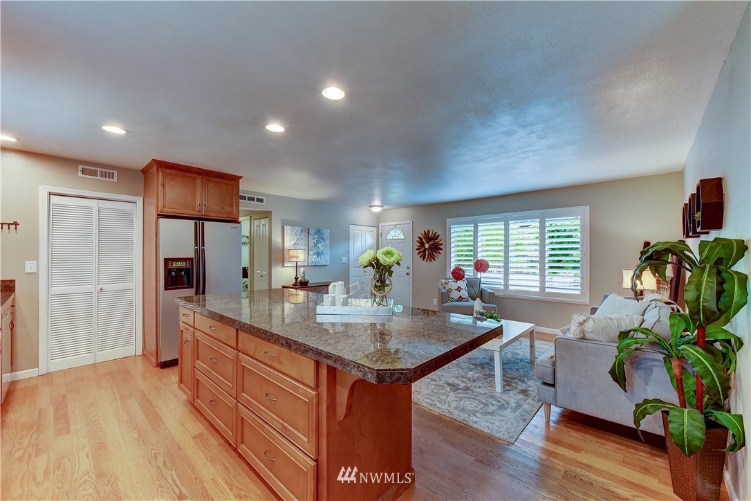 110 219th Place Southeast Bothell, WA 98021 - Photo 10 of 27 a kitchen with sink refrigerator and dining table