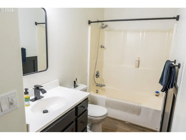 a backyard of a house with table and chairs