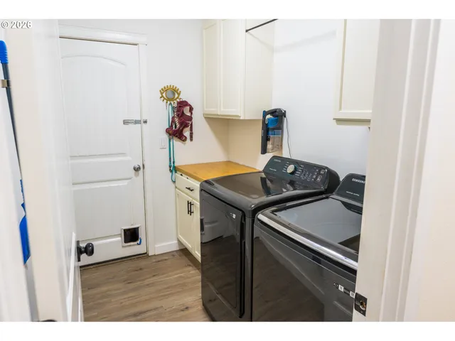 a view of a chairs and table in backyard of the house