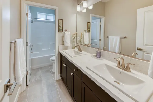 a bathroom with a tub sink and a mirror