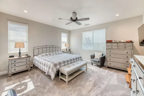 a living room with furniture and a ceiling fan
