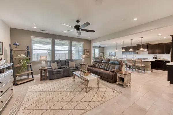 a kitchen with a table chairs refrigerator and microwave