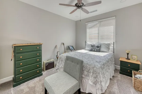 a spacious bedroom with a bed and a cabinets