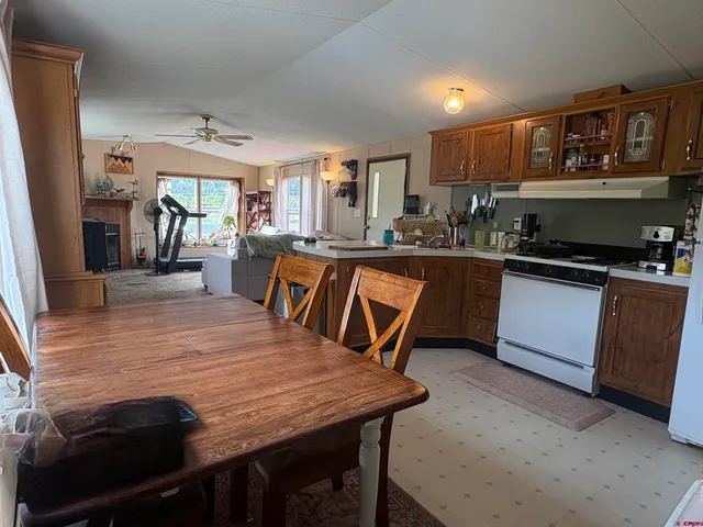 a kitchen with a table chairs microwave and cabinets