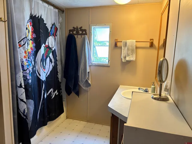 a view of walk in closet with clothes