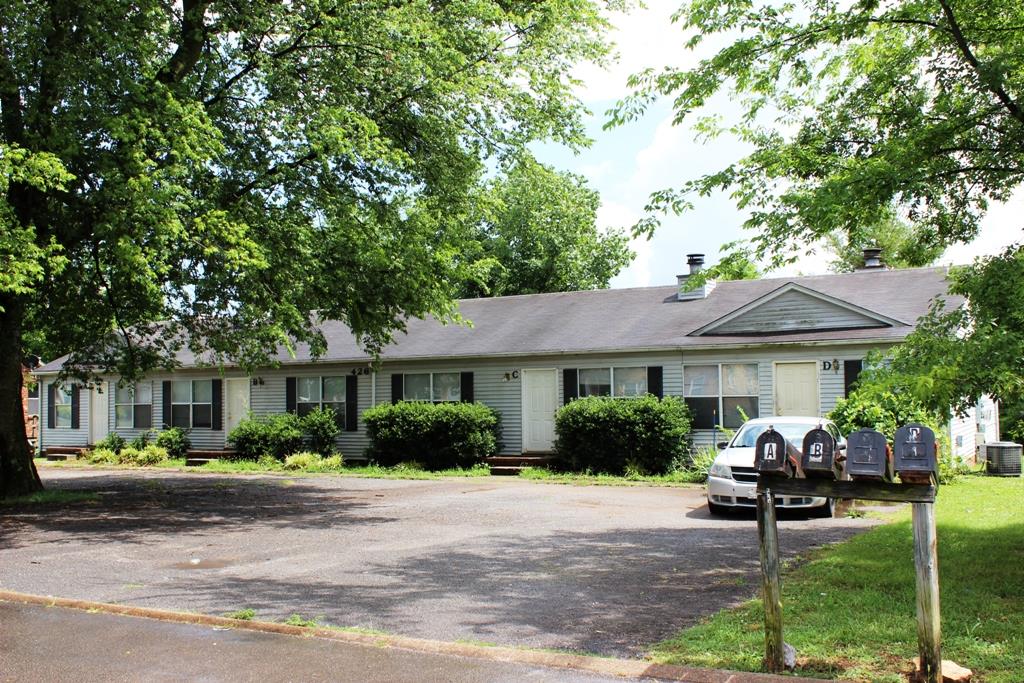 a view of a house with backyard sitting area and garden