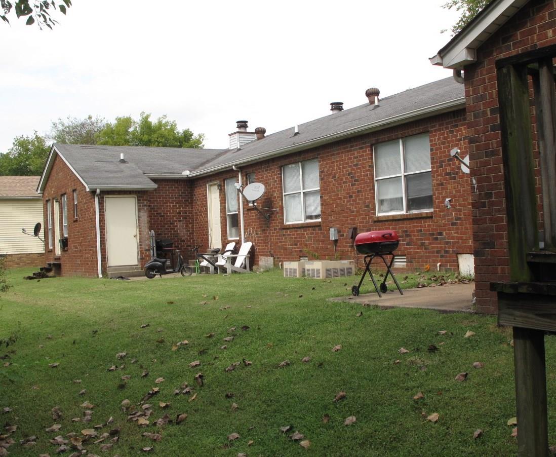 426 Lawson Road Smyrna, TN 37167 - Photo 2 of 3 a backyard of a house with table and chairs