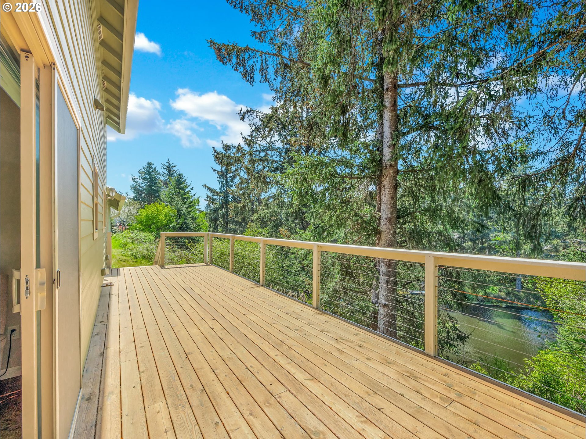 1077 Southwest Ridge Road Warrenton, OR 97146 - Photo 12 of 46 a balcony with wooden floor and fence