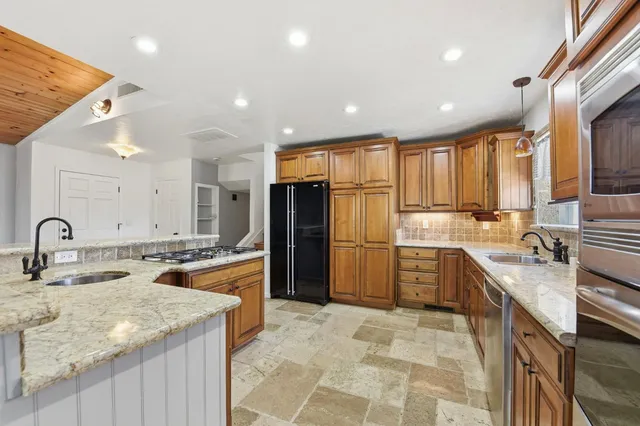 a kitchen with a sink stove and refrigerator