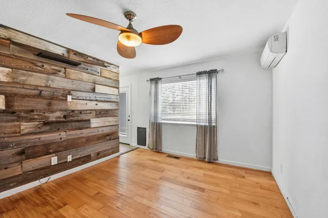 a view of a room with wooden floor and windows
