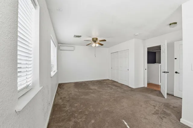 a view of a livingroom with a ceiling fan and window