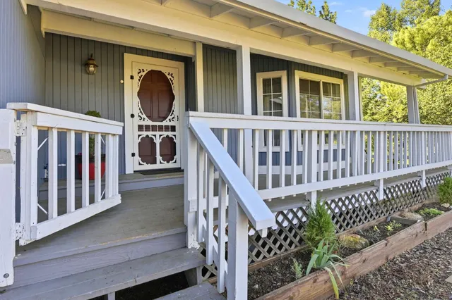 a view of a house with wooden deck