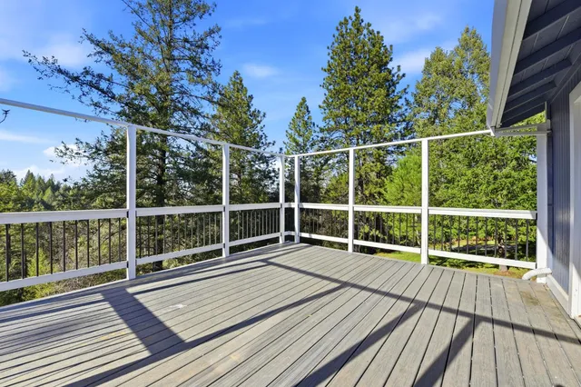 a view of a balcony with wooden floor