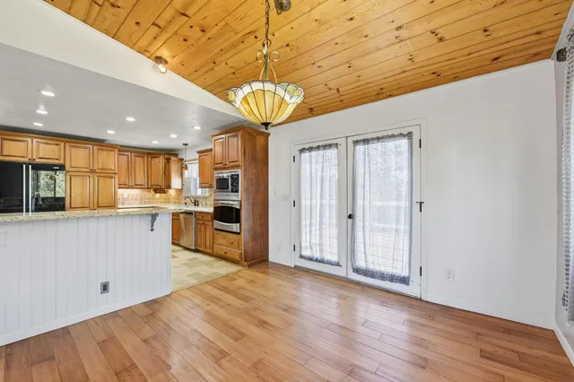 a view of a kitchen with a sink and wooden floor