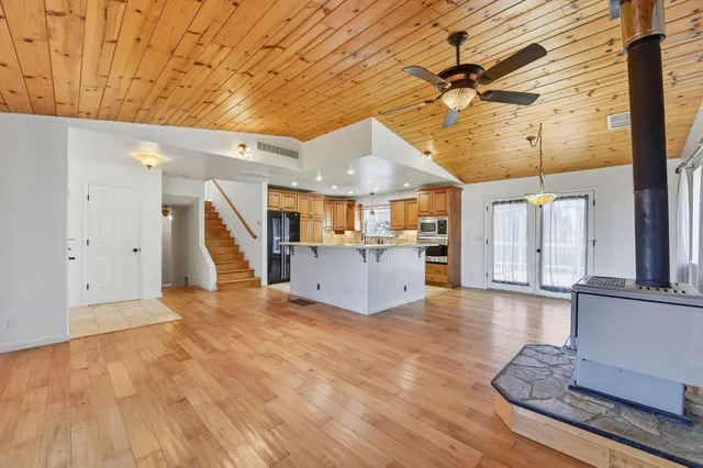a view of a livingroom with furniture and a kitchen