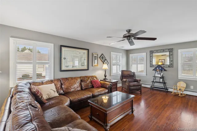 a living room with furniture a wooden floor and a window