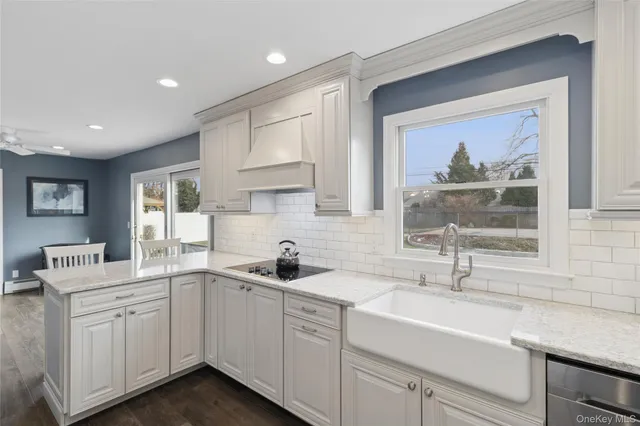 a kitchen with a sink cabinets and window