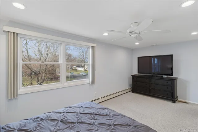 a bedroom with furniture and a flat screen tv