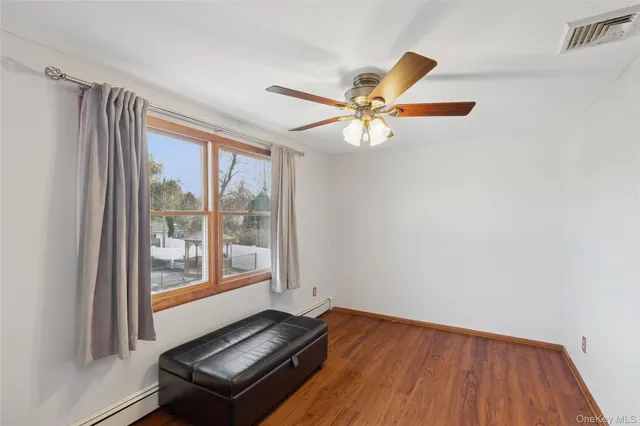 a view of a room with wooden floor and window