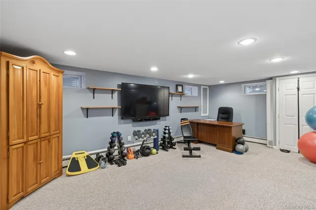 a view of a livingroom with workspace and a window