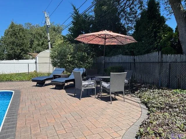 a view of backyard with seating space and trees