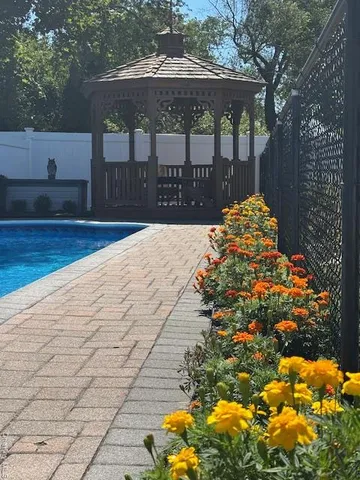 a front view of a house with a yard and green space