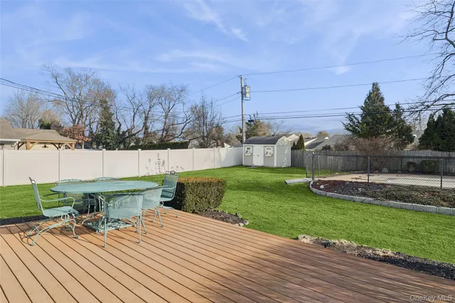 a view of a backyard with plants and outdoor seating
