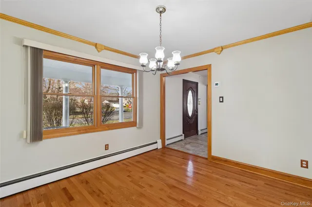 a view of a room with window wooden floor and chandelier