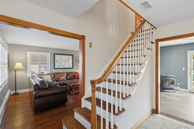 a view of a livingroom with wooden floor and stairs