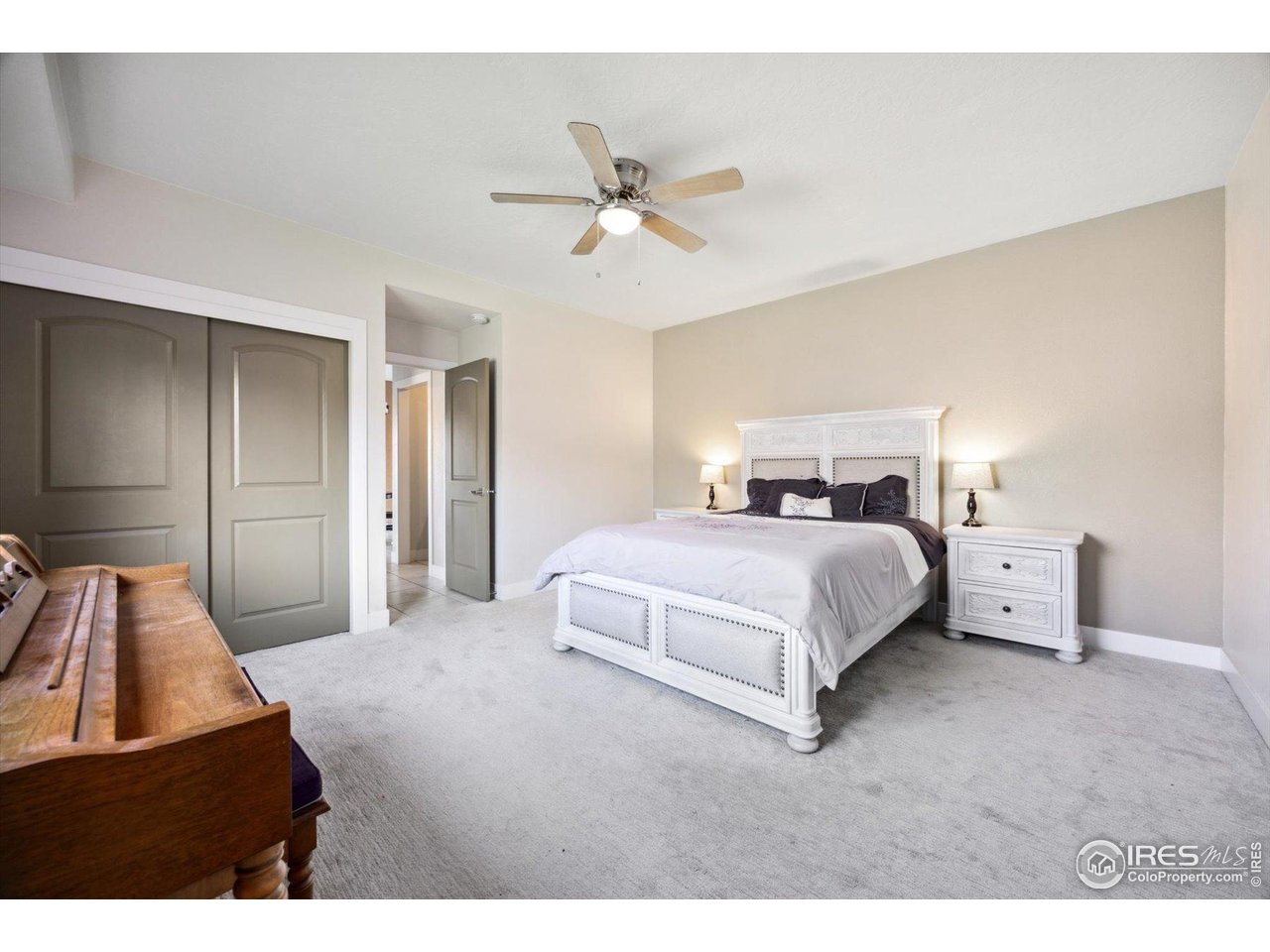 403 Double Tree Drive Greeley, CO 80634 - Photo 16 of 49 a bedroom with a bed and a large mirror