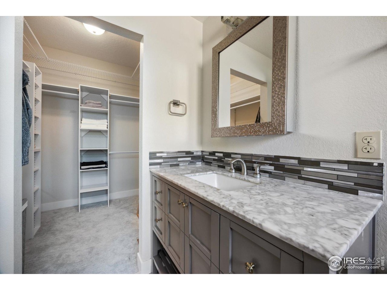 403 Double Tree Drive Greeley, CO 80634 - Photo 18 of 49 a bathroom with a granite countertop sink and a mirror
