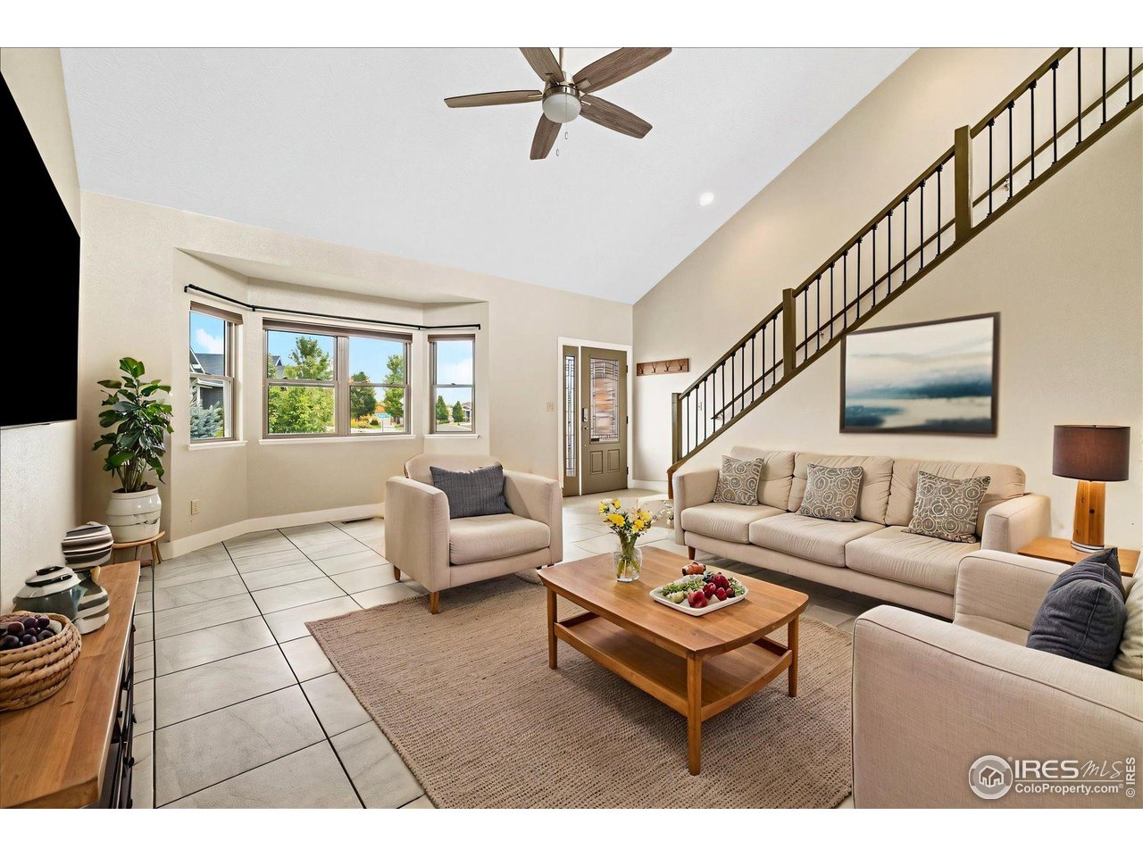 403 Double Tree Drive Greeley, CO 80634 - Photo 2 of 49 a living room with furniture and a potted plant