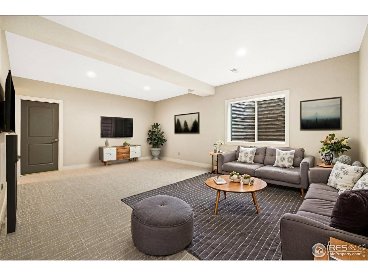 403 Double Tree Drive Greeley, CO 80634 - Photo 30 of 49 a living room with furniture and a flat screen tv