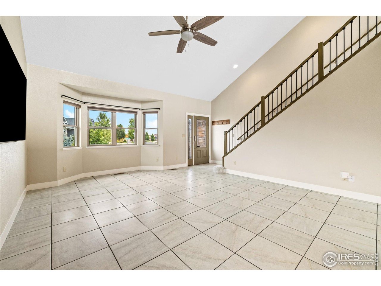 403 Double Tree Drive Greeley, CO 80634 - Photo 3 of 49 a view interior of a house with wooden floor windows and ceiling fan