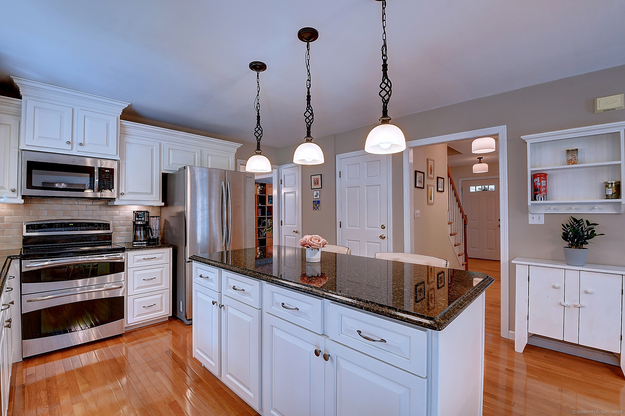884 Moss Farms Road Cheshire, CT 06410 - Photo 11 of 39 a kitchen with stainless steel appliances granite countertop a sink a stove and a wooden floors
