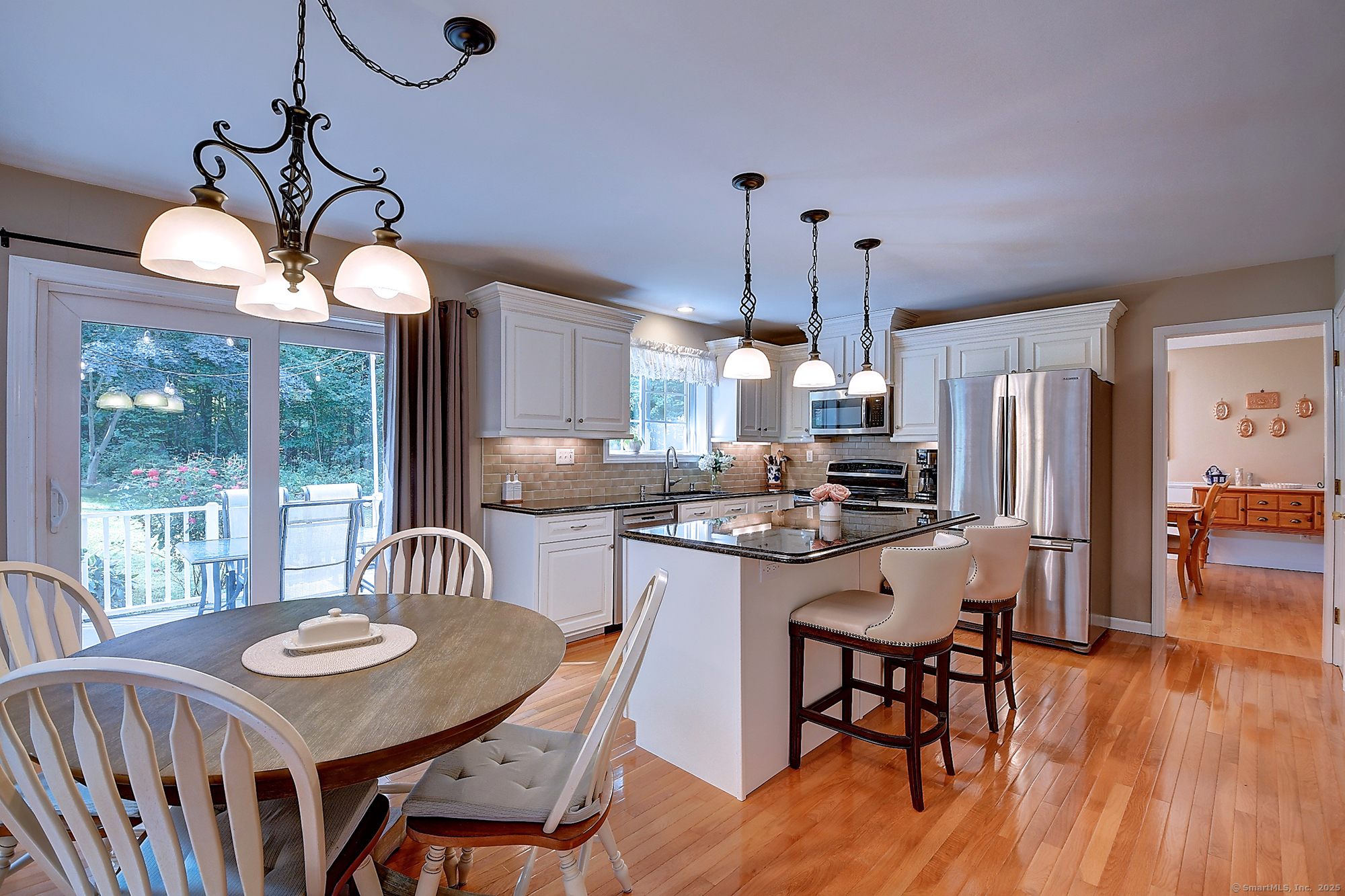 884 Moss Farms Road Cheshire, CT 06410 - Photo 12 of 39 a view of a dining room with furniture window and wooden floor