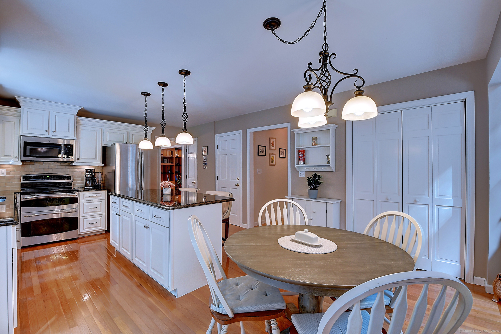 884 Moss Farms Road Cheshire, CT 06410 - Photo 13 of 39 a large kitchen with a table and chairs