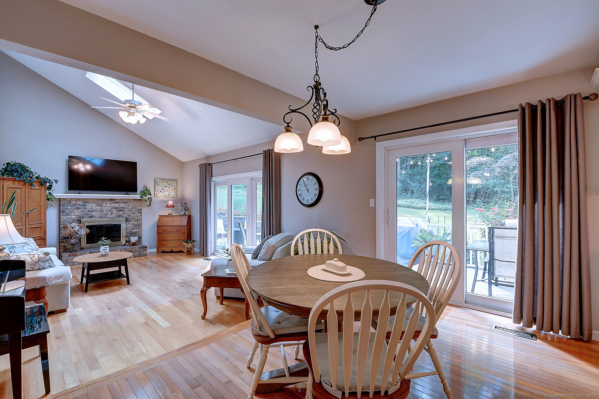 884 Moss Farms Road Cheshire, CT 06410 - Photo 14 of 39 a dining room with furniture a chandelier and wooden floor