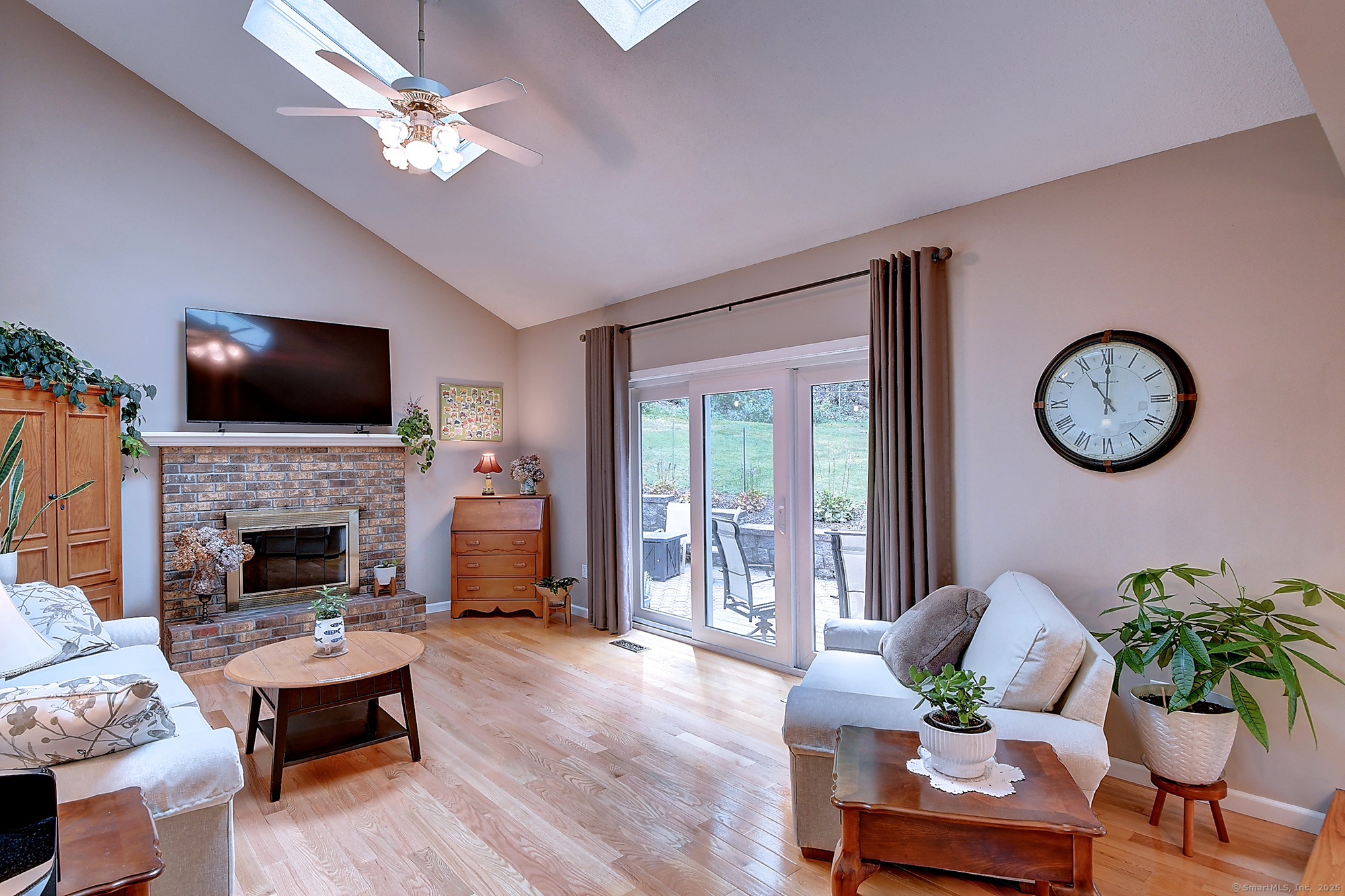 884 Moss Farms Road Cheshire, CT 06410 - Photo 15 of 39 a living room with furniture a fireplace and a flat screen tv