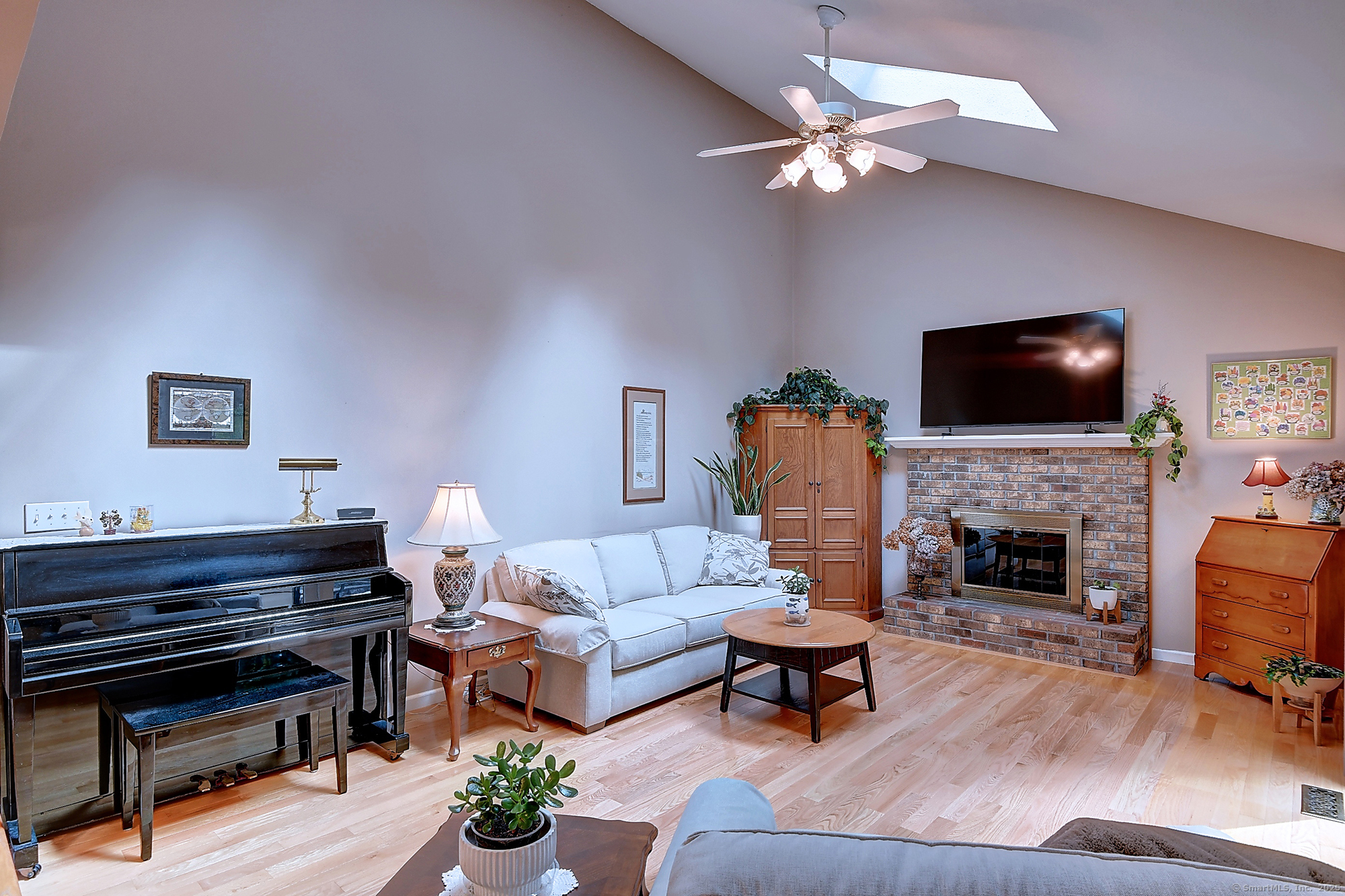 884 Moss Farms Road Cheshire, CT 06410 - Photo 16 of 39 a living room with furniture a fireplace and a flat screen tv