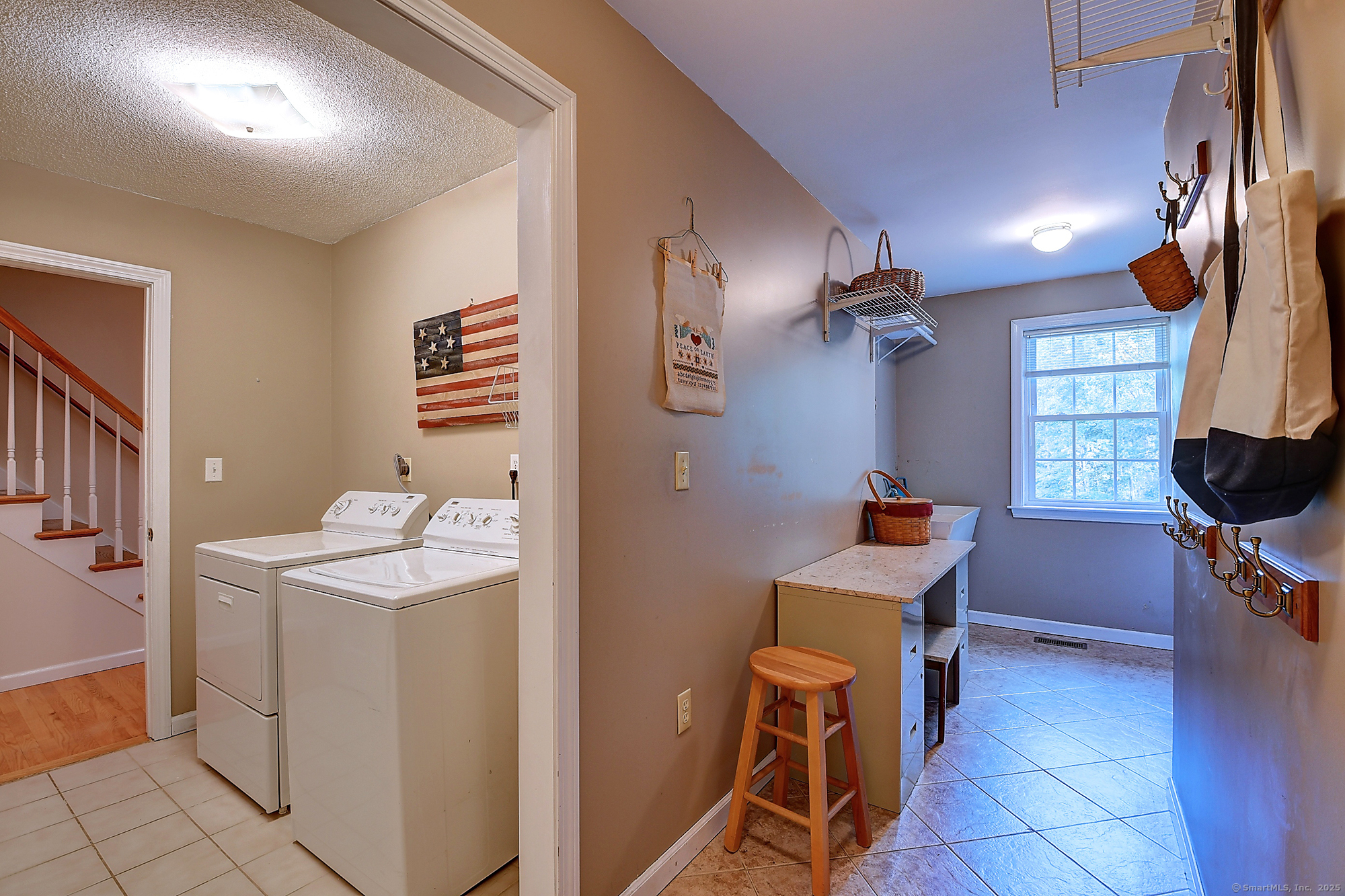 884 Moss Farms Road Cheshire, CT 06410 - Photo 19 of 39 a room with furniture a washer and dryer