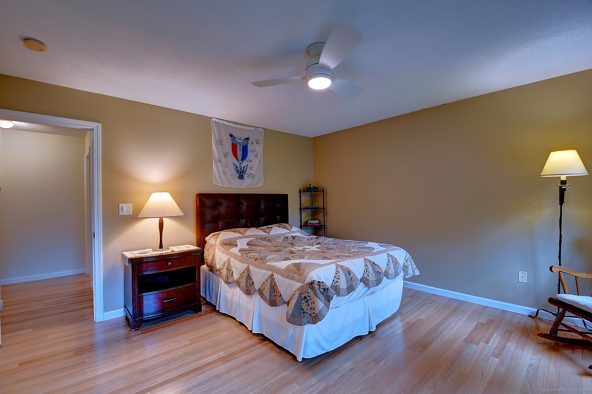 884 Moss Farms Road Cheshire, CT 06410 - Photo 27 of 39 a bedroom with a bed and wooden floor