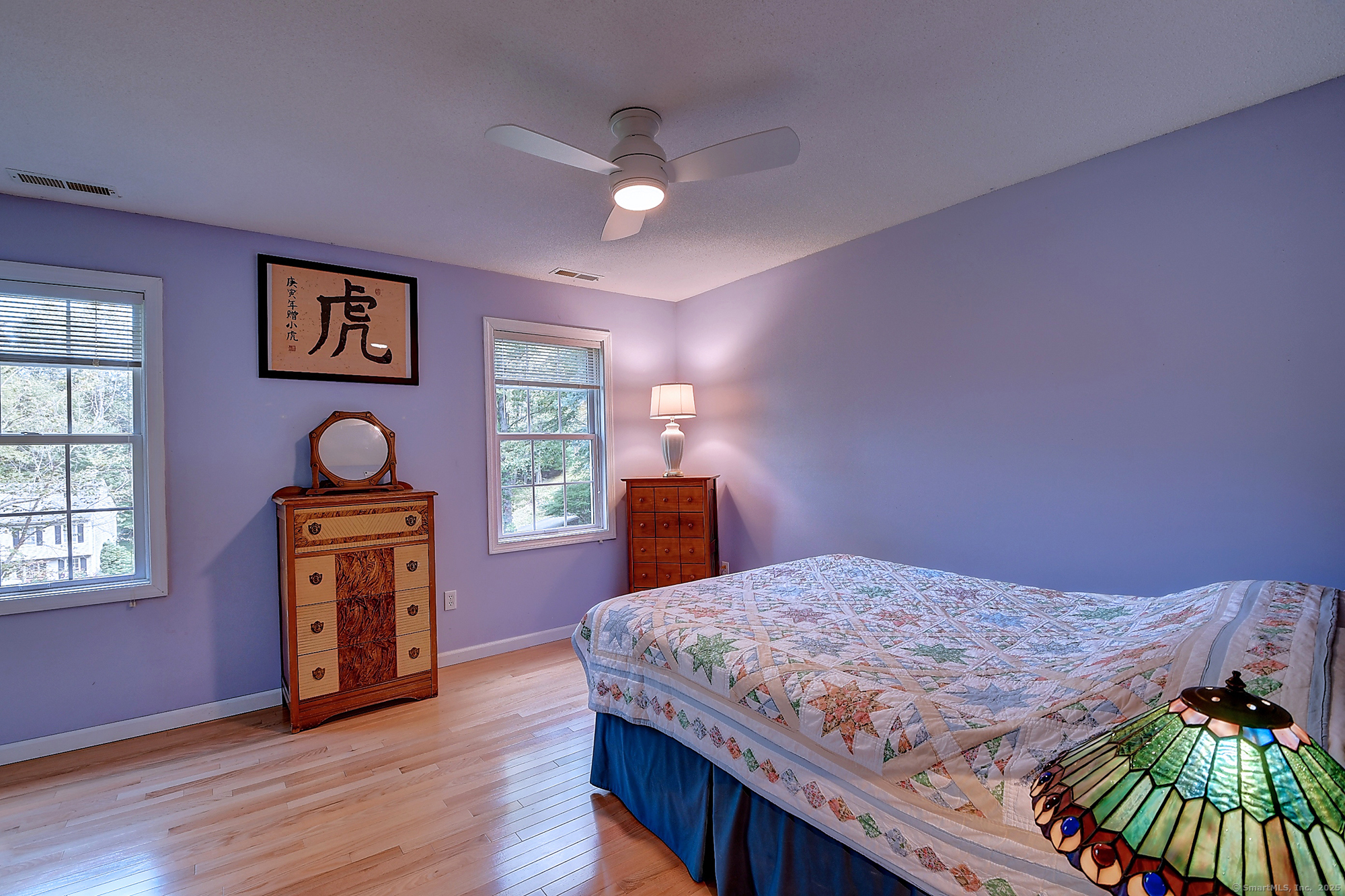 884 Moss Farms Road Cheshire, CT 06410 - Photo 28 of 39 a bedroom with a bed and a chandelier