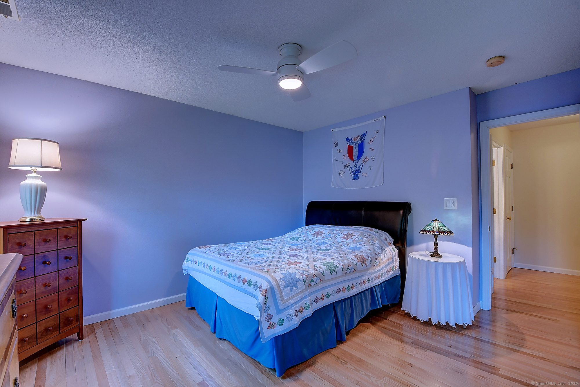 884 Moss Farms Road Cheshire, CT 06410 - Photo 29 of 39 a bedroom with a bed and wooden floor