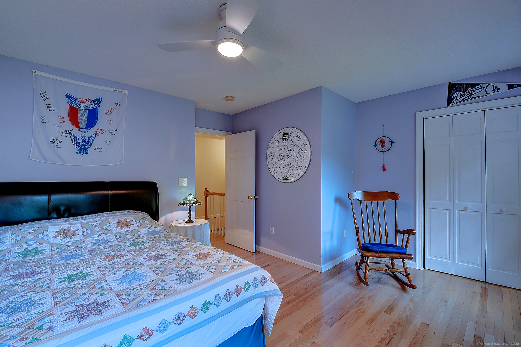 884 Moss Farms Road Cheshire, CT 06410 - Photo 30 of 39 a bedroom with a bed and wooden floor