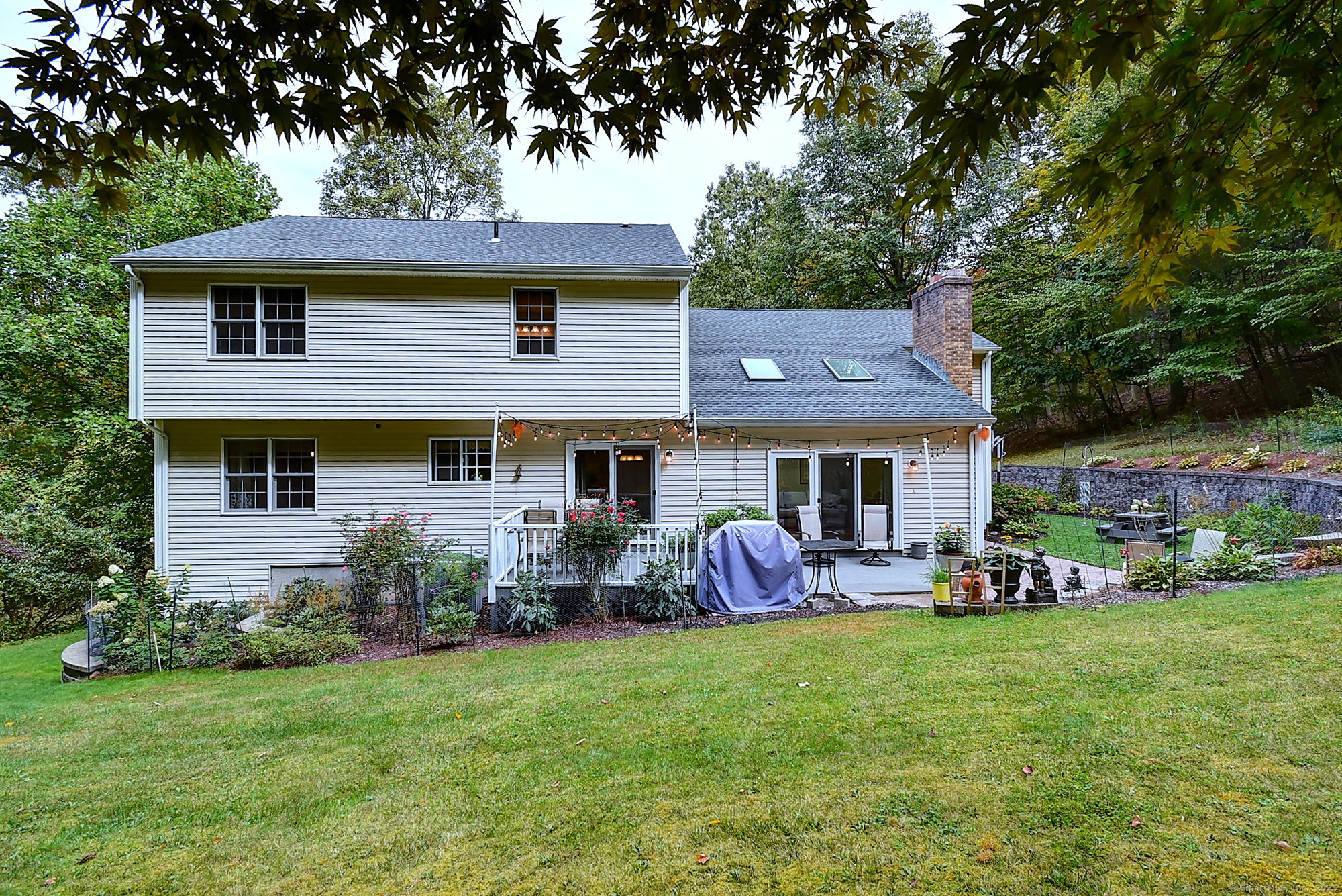 884 Moss Farms Road Cheshire, CT 06410 - Photo 36 of 39 a front view of a house with a garden and trees