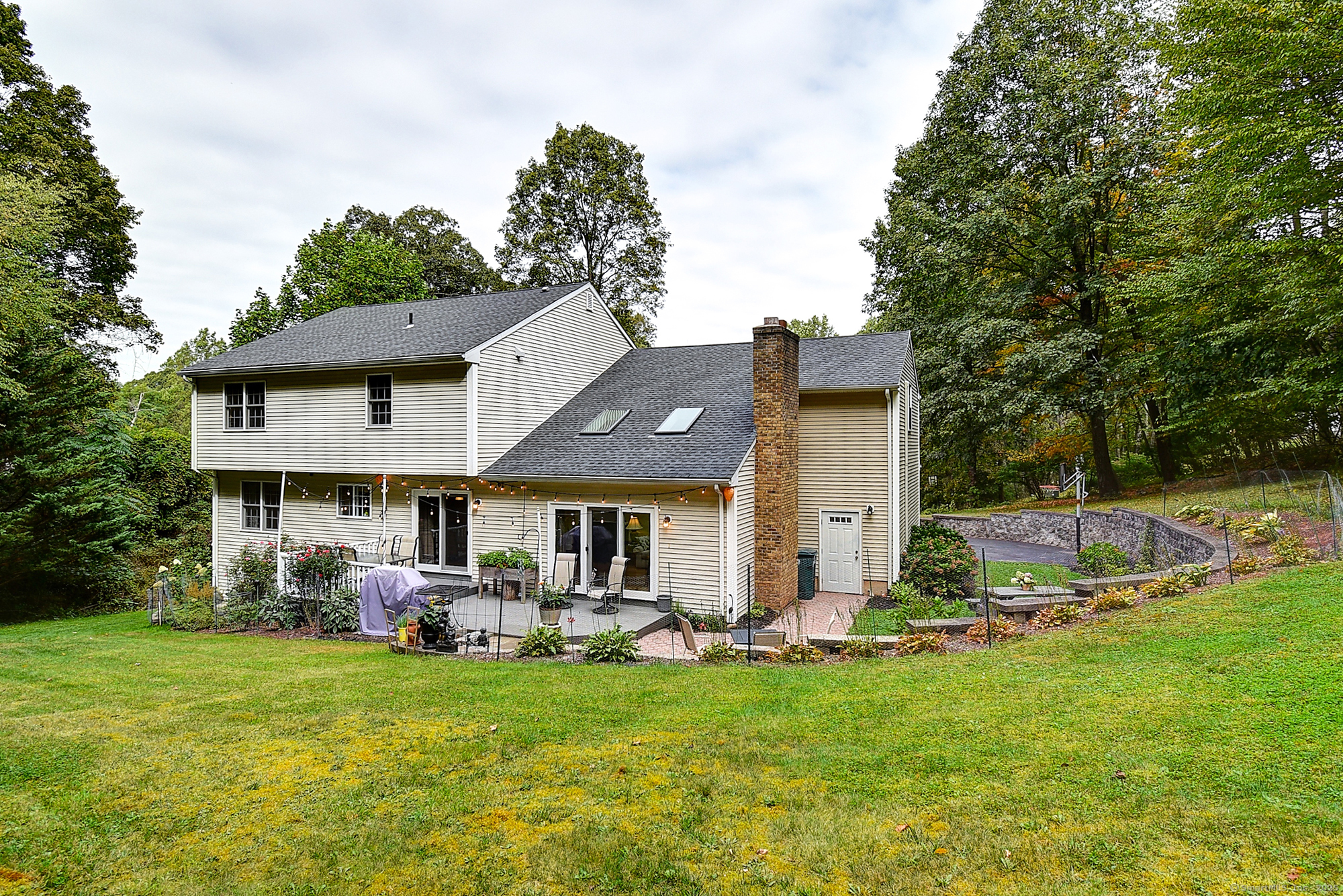 884 Moss Farms Road Cheshire, CT 06410 - Photo 37 of 39 a aerial view of a house with table and chairs under an umbrella
