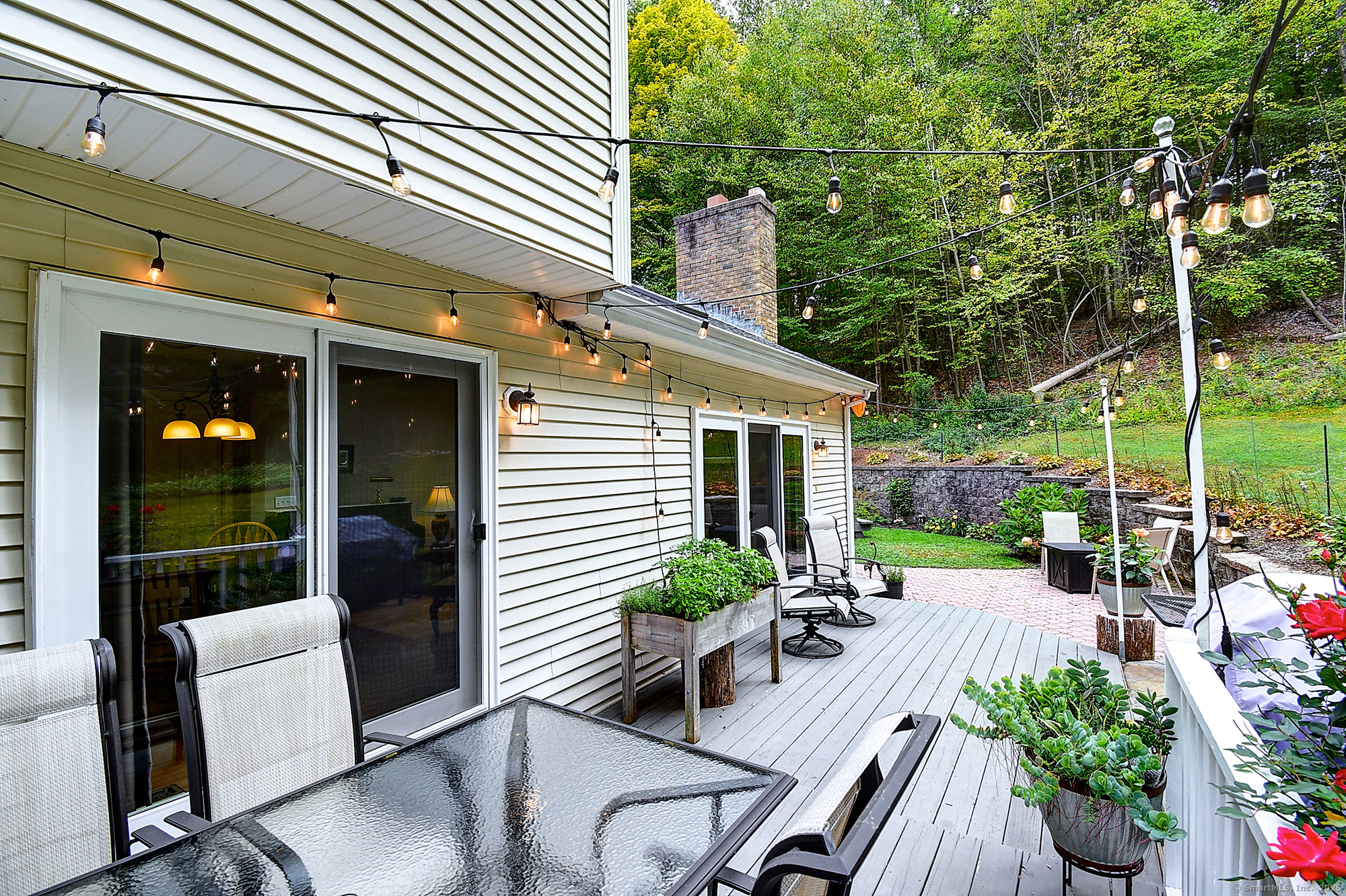 884 Moss Farms Road Cheshire, CT 06410 - Photo 39 of 39 a view of a patio with couches chairs potted plants and floor to ceiling window