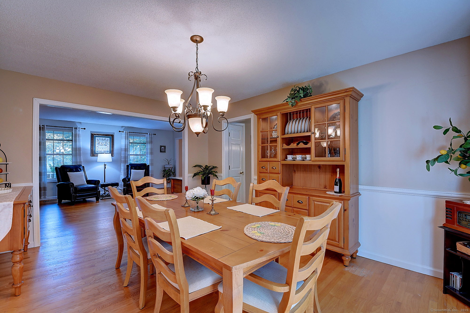 884 Moss Farms Road Cheshire, CT 06410 - Photo 6 of 39 a view of a dining room with furniture wooden floor and chandelier