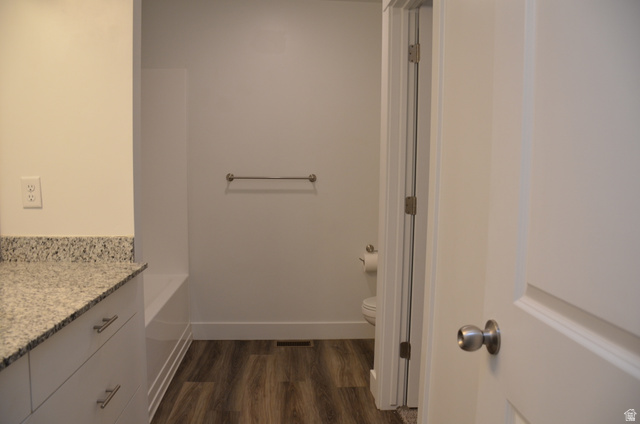 1842 South 1280th Street West Logan, UT 84321 - Photo 13 of 21 Bathroom featuring a vanity with a speckled countertop, white cabinetry with brushed nickel pulls, and wood-finish flooring